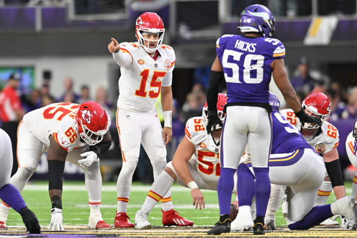 Oct 8, 2023; Minneapolis, Minnesota, USA; Kansas City Chiefs quarterback Patrick Mahomes (15) directs the offense as guard Trey Smith (65) and center Creed Humphrey (52) and Minnesota Vikings linebacker Jordan Hicks (58) look on during the fourth quarter at U.S. Bank Stadium.